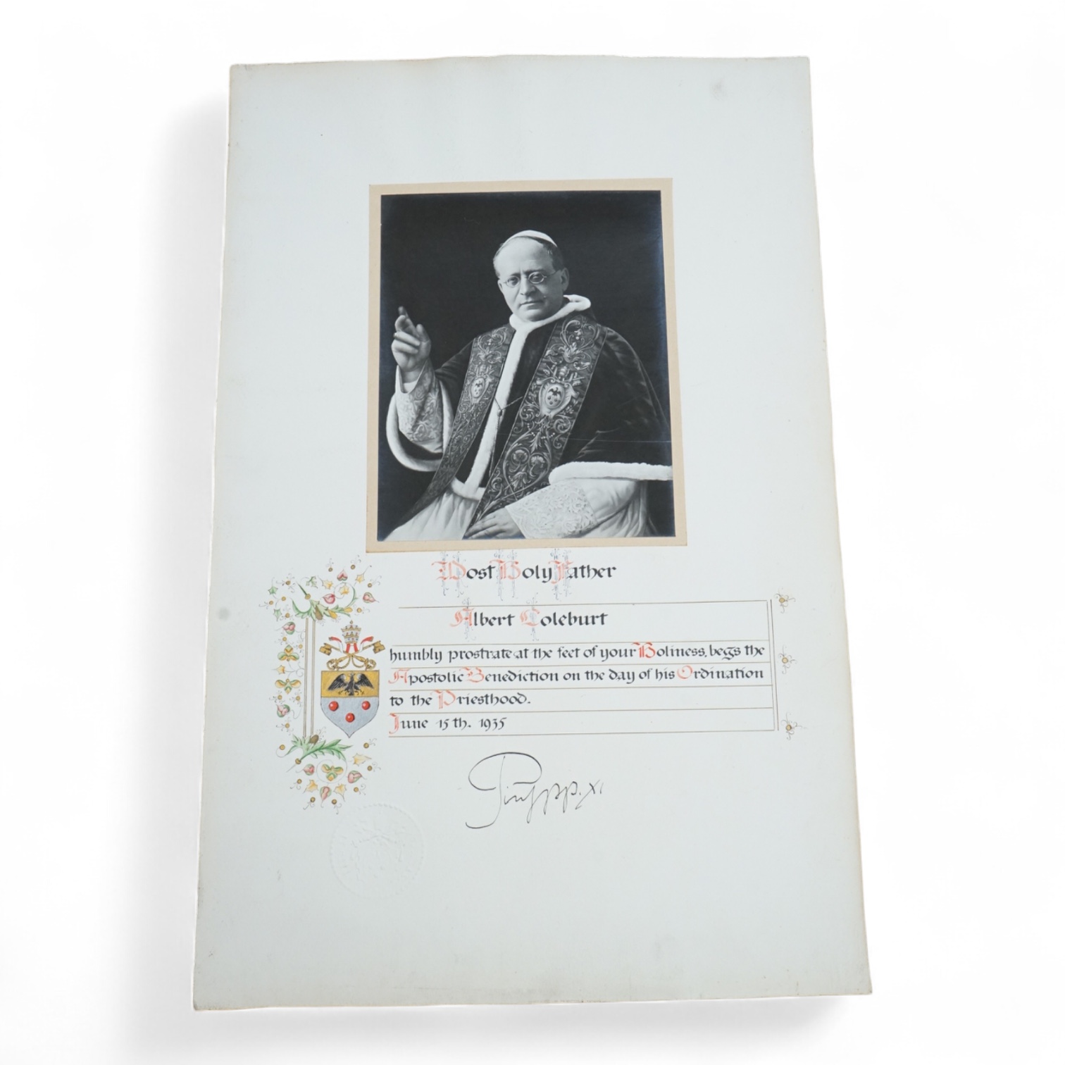 An autographed photograph of Pope Pius XI, on the celebration of the ordination of Albert Coleburt, priested on June 15th, 1935, decorated with the people coat of arms and embossed with Pius XI’s official blind stamp, 52